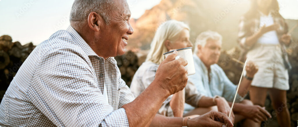 Group of retired adults sitting around a campfire