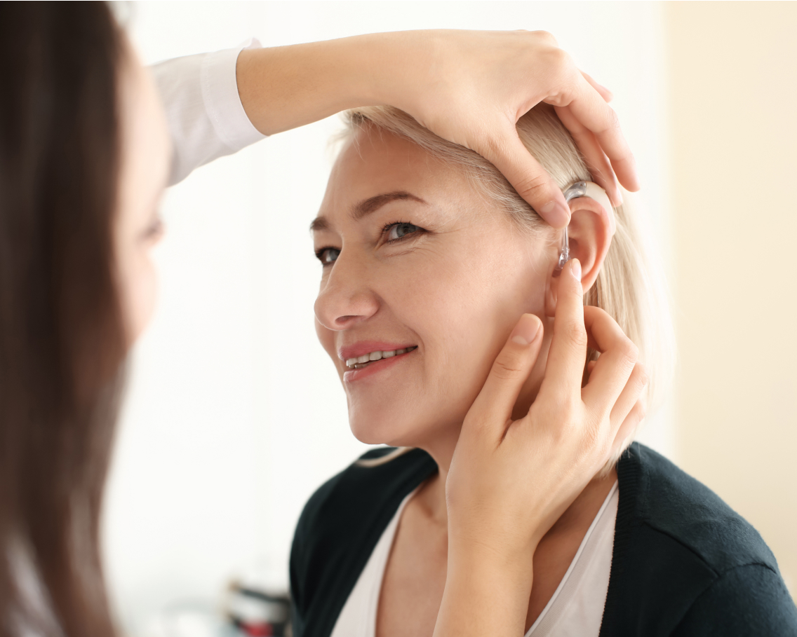Woman getting a hearing aid placed