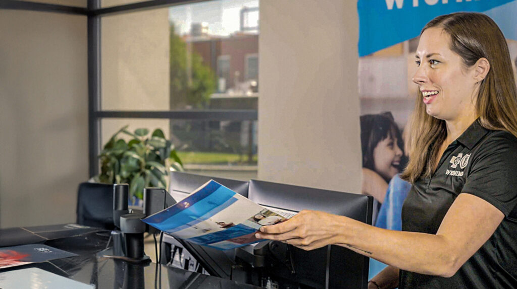 Agent enrolling a member talking at desk