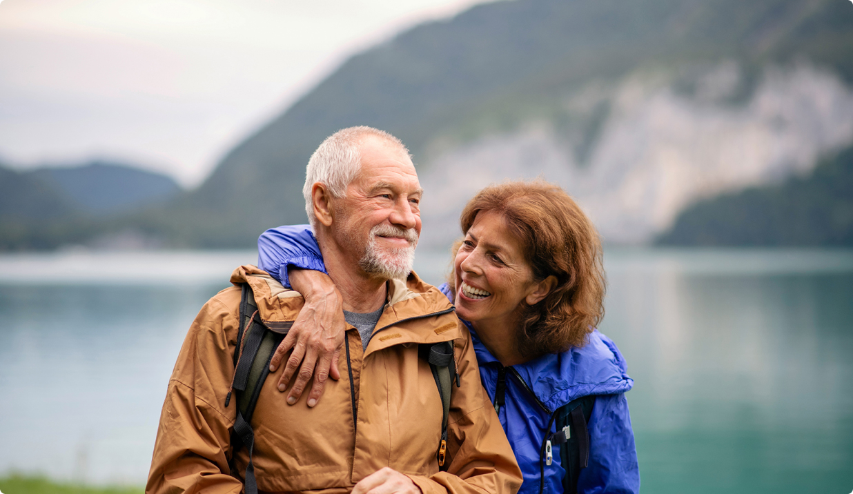 Couple embracing in front of a mountain