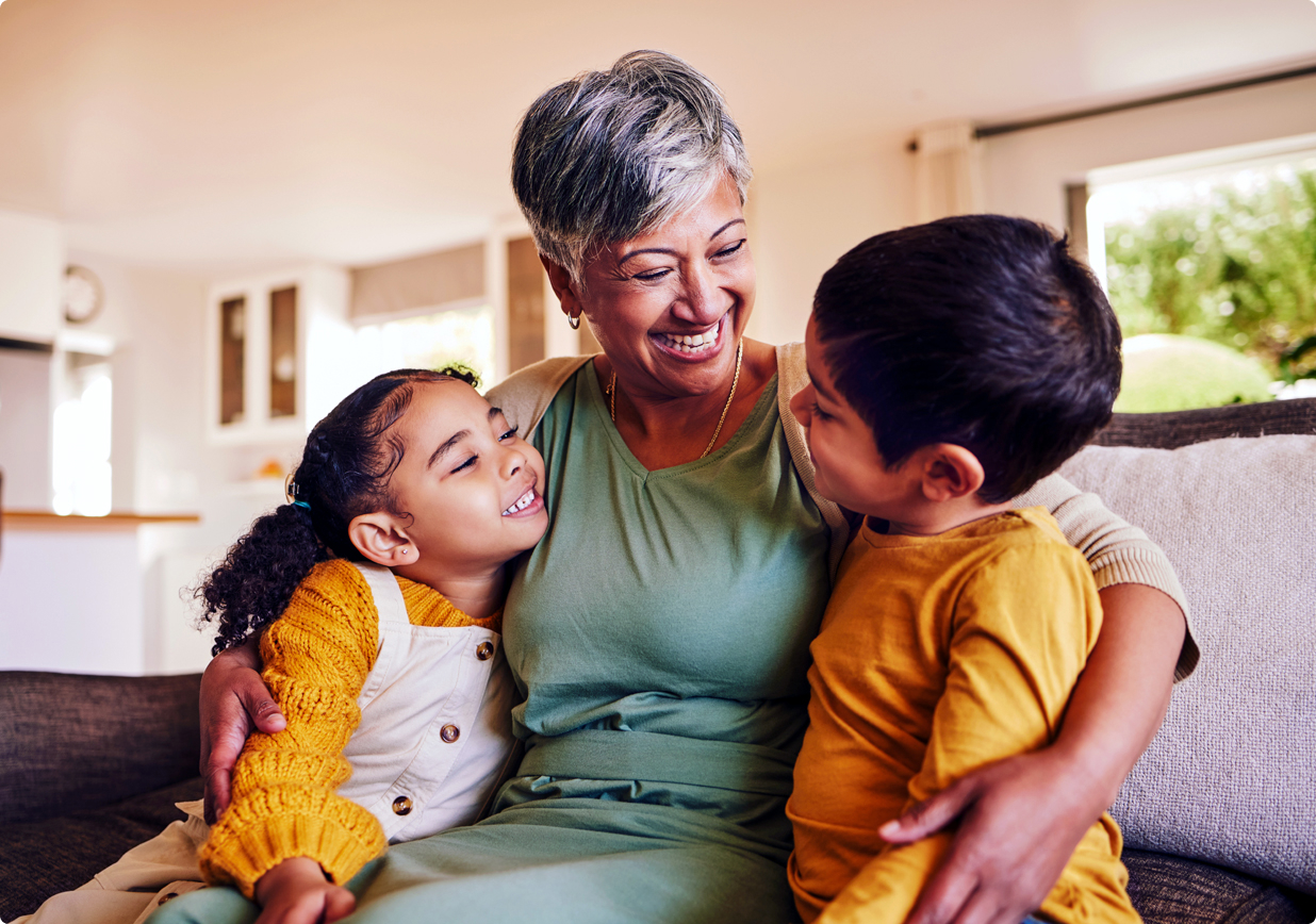 A grandmother embracing her grandchildren